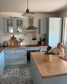 a young child sitting on a kitchen counter