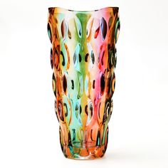 a multicolored glass vase sitting on top of a white table