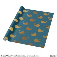 a blue wrapping paper with gold whales on it