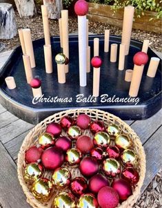 a basket filled with christmas balls next to an old fashioned pan full of candles and ornaments