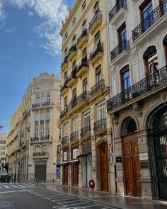 an empty city street with tall buildings on both sides