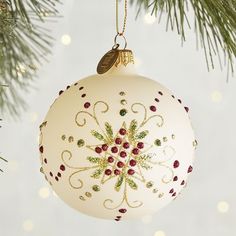 a white ornament hanging from a christmas tree