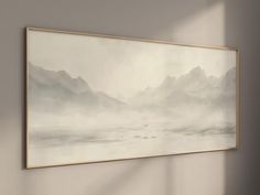 a painting hanging on the wall in an empty room