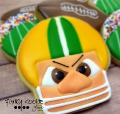 cookies decorated like football players with green and white stripes on them, including one man's face