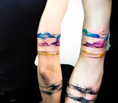 two people with matching tattoos on their arms