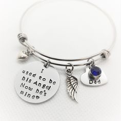 "Personalized Memorial Bracelet, Memorial Jewelry, Loss of Father Bangle, Remembrance Jewelry, In Memory of Bracelet, Daughter Gift, Sympathy This piece features ■ One 6mm Birthstone channel of your choice ■ One 1/2\" heart disc with the loved one of your from the drop down menu. ■ One 3/4\" hand stamped disc with the wording \"I used to be his angel Now he's mine\" and a small hand stamped heart ■ One Tibetan small silver heart charm ■ One Tibetan silver angel wing charm ■ One adjustable bangle Personalized Round Bracelets For Keepsake, Adjustable Stainless Steel Keepsake Jewelry, Engraved Silver Bracelet For Memorial, Silver Engraved Bracelet For Memorials, Memorial Engraved Silver Bracelets, Silver Engraved Bracelet For Memorial, Adjustable Sterling Silver Memorial Jewelry, Adjustable Commemorative Jewelry, Engraved Adjustable Jewelry For Memorials