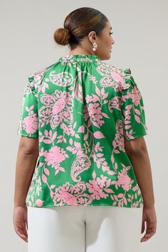 You'll be blossoming with the Anela Floral Mei Split Neck Satin Top! A pink, floral print decorates a playful silhouette with green background. It features a ruffle split neckline with flowy short sleeves. It can be worn tucked into high waisted shorts with sandals.- Ruffle details- Split neckline- Satin- Flutter sleeves- Color: Pink GreenSize + Fit - Model is 5'9" and wearing size 2X- Measurements taken from size 2X - Chest: 27"- Length: 29" Fabric Self:100%Polyester Style Number STT16762DRX Elegant Floral Print Top With Split Neck, Spring Floral Print Split Neck Top, Feminine Floral Print Top With Split Neck, Pink Floral Print Split Neck Blouse, Green V-neck Blouse With Tropical Print, Burning Love, Flowy Shorts, Pink Floral Print, Satin Blouse