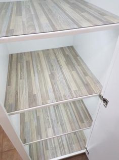 two shelves with wooden flooring in the middle and one shelf on the other side