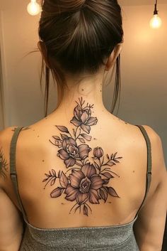 a woman with a flower tattoo on her back