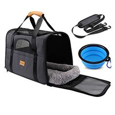 an open pet carrier with two bowls and a leash