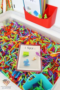 a box filled with lots of different colored plastic letters and numbers on top of it