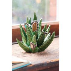 a small green plant sitting on top of a window sill next to a window