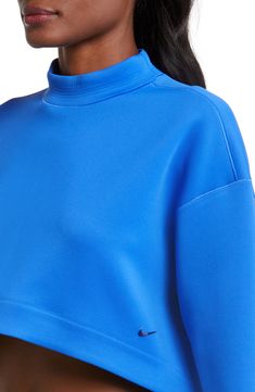 An oversized mock-neck sweatshirt features moisture-wicking Dri-FIT techology that keeps you comfy, while a cropped length creates a cool, modern look. 15 1/2" front length; 18" back length (size Medium) Mock neck 93% polyester, 7% spandex Machine wash, tumble dry Imported Sports Top With Relaxed Fit And Funnel Neck, Versatile Funnel Neck Top With Ribbed Cuffs, Functional Funnel Neck Tops For Fall, Functional Fall Tops With Funnel Neck, Sporty Funnel Neck Top With Ribbed Cuffs, Sporty Top With Funnel Neck And Ribbed Cuffs, Sporty Tops With Funnel Neck And Ribbed Cuffs, Nike Oversized Long Sleeve Activewear, Sporty Workout Tops With Funnel Neck