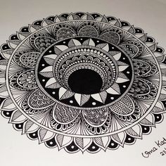 a black and white drawing of a circular object with an intricate design on the side