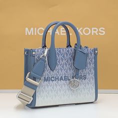 Michael Kors Mirella Extra-Small Ombr Logo Crossbody Xbody Shopper Bag Denim Nwt Authentic Whether You’re Heading To A Daytime Event Or Simply Running Errands, The Mirella Will Meet The Moment. Fit All Your Essentials Into This Charming Mini Tote, Which Can Be Carried By The Top Handles Or Worn Cross-Body Thanks To A Removable Strap. Printed With Our Initials In An Ombr Finish, It’s A Reliable Way To Spice Up Any Outfit. Crossbody Bag Logo-Print Canvas 90% Coated Canvas/10% Polyester Trim 1: 60% Coach Men’s Cross Body Bag, Cross Body Purse Michael Kors, Michael Kors Shopper Bag, Silver Bags With Logo For Everyday Use, Blue Top Handle Shoulder Bag With Logo, Blue Top Handle Bag With Logo, Blue Crossbody Shoulder Bag With Logo, Blue Logo Crossbody Shoulder Bag, Blue Logo Crossbody Bag