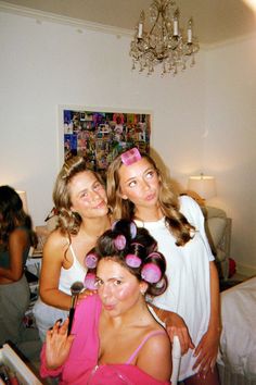 three young women are posing for the camera with their hair rollers in front of them