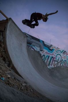 a man riding a skateboard up the side of a ramp