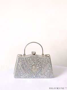 BagForLove - Sparkling Rhinestone Chain Clip Box Bag: Ideal Bridal Purse for Weddings, Proms & Parties Product Description Color Silver Details Rhinestone Bag Size Small Pattern Type All Over Print Type Novelty Bag Material Iron Alloy Size Chart INCH CM Bag Height Bag Length Bag Width Handle Height Strap Length 5.7 inch 9.3 inch 3.9 inch 3.1 inch 47.2 inch Bag Height Bag Length Bag Width Handle Height Strap Length 14.5 cm 23.5 cm 10 cm 8 cm 120 cm Details Pictures Similar Products h2 { text-align: center; } /* æ¢è¡ */ li{ white-space: normal; word-break: break-all; word-wrap: break-word; } .red-box { width: 100%; display: flex; flex-direction: row; flex-wrap: wrap; justify-content: center; } .red-box > div { width: 190px; height: 250px; margin: 10px; } .red-box > div > a > img { width: 1 Glamorous Sparkling Clutch For Weddings, Elegant Wedding Clutch With Bling, Rhinestone Evening Bag For Wedding, Silver Crystal Bags For Gifts, Silver Crystal Bag For Gift, Silver Crystal Bags As Gifts, Silver Handheld Clutch With Rhinestones, Silver Embellished Crystal Clutch, Glamorous Wedding Bag With Bling