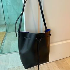 Mansur Gavriel Bucket Bag, Black With Electric Blue Interior, New Never Worn. Pristine Condition. Comes With Pouch Inside And Dust Bag. Designer Black Bucket Bag For Everyday, Formal Blue Bucket Bag With Adjustable Strap, Mansur Gavriel Bucket Bag, Blue Interior, Mansur Gavriel, Electric Blue, Black Blue, Bucket Bag, Crossbody Bags