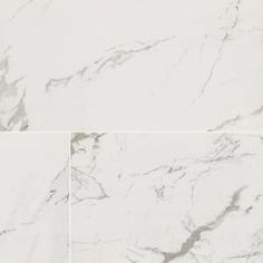 two white marble tiles are shown in this image