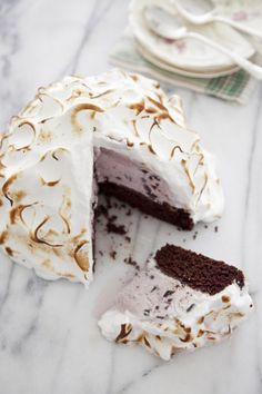 a cake that has been cut in half on a marble counter top with one slice missing