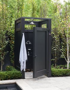 an outdoor shower in the middle of a garden