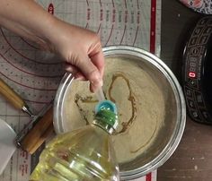 a person is pouring something into a bowl