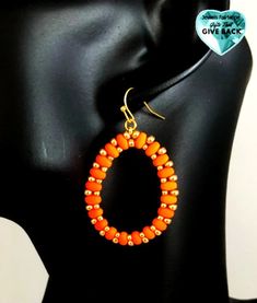 Bright Orange Woven Earrings Lightweight earrings handwoven by me Each earrings lay on gold plated french hooks . Earrings measure roughly 2 inches Be grateful, be happy, be hopeful, spread love. Look Great and Donate! If you have any questions, please feel free to email us! **Colors may vary between online viewing. All monitors display color differently; please takes this into consideration when placing your order Gold Beaded Earrings With French Hook As Gift, French Hook Beaded Drop Earrings, Gold Beaded Dangle Earrings With French Hook, Handmade Oval Beaded Earrings For Gift, Gold Beaded Teardrop Earrings For Gift, Handmade Oval Beaded Earrings As Gift, Gold Teardrop Earrings With Round Beads For Gifts, Adjustable Teardrop Earrings With Gold Beads, Orange Earrings With Gold Beads As A Gift