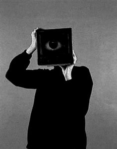 a person holding up a box with an eye in it's center to look at the sky