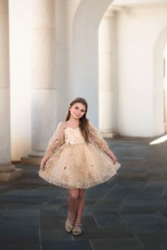 Part of our luxury collection, this dress is a stunning work of art. With it's sweetheart neckline and sparkling gold design, this dress will have all eyes on her. A lace up back and tutu pettiskirt will be perfect for the girl and her twirl! 100% poly Fully lined No glitter Machine wash, hang dry Glamorous Gold Tulle Dresses, Elegant Gold Tulle Dress, Elegant Gold Princess Dress For Party, Elegant Gold Glitter Tulle Dresses, Gold Sequined Princess Dress For Party, Gold Sequin Princess Dress For Party, Elegant Gold Princess Dress For Fancy Dress, Elegant Gold Princess Dress For Fancy Dress Occasions, Gold Prom Dress With Sweetheart Neckline