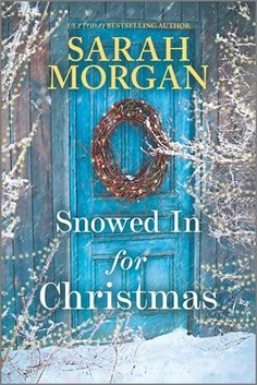 the cover of snowed in for christmas by sarari morgan, with a wreath on it