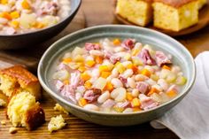 there is a bowl of soup and bread on the table