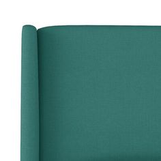 an upholstered headboard made out of fabric in teal green, on a white background