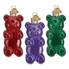 three different colored teddy bears are hanging from the same line as each other, one has a gold tag on it's ear