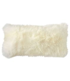 a white sheepskin pillow on a white background