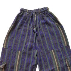 Nice comfy pants for going to the beach, camping, or spending the day at home.These hippie pants have 2 pockets on the front + 2 cargo pockets +1 pocket on the back.They are high-waisted boho pants. They have a drawstring in the waist. It was handmade by Ecuadorian artisans using the foot-treadle loom technique.Materials:75% cotton and 25% acrylic Measurements:Waist circumference: stretches from 24" up to 34"Hip circumference: 42"Rise: 11"Inseam: 28"Total Length: 39"Thigh: 12"Leg opening: 8" Car Baggy Harem Pants With Pockets For Vacation, Blue Relaxed Fit Harem Pants With Pockets, Bohemian Bottoms With Pockets For Vacation, Wide-leg Cargo Pants With Pockets For Festivals, Wide Leg Cargo Pants With Pockets For Festival, Wide Leg Cargo Pants For Festivals, Beach Harem Bottoms With Pockets, Cotton Cargo Pants With Pockets For Beach, Beach Cotton Cargo Pants With Pockets