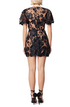 Be the life of the party in this puff-sleeve minidress featuring floral embroidery all over paired with three-dimensional appliqué details for extra texture. 33" length (size Medium) Stretch lining V-neck Short sleeves 100% polyester Dry clean Imported Chic Fitted Embroidered Evening Dress, Embroidered Mini Party Dress, Chic Fitted Embroidered Cocktail Dress, Party Embroidered Dress With Floral Applique And Short Sleeves, Short Sleeve Embroidered Dress With Floral Applique For Party, Embroidered Mini Dress For Party, Fitted Mini Dress With Floral Applique, Evening Mini Dress With Floral Embroidery, Chic Embroidered Mini Dress For Night Out