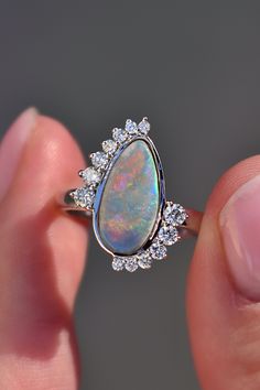 In ancient Rome, it was believed that opal brings love and hope. We have no doubt that it’s exactly the gem that symbolizes a strong alliance. We have created a custom engagement opal ring with diamonds for those who value love and reliability in the relationship. Creating the unique design of the ring we wanted to combine two symbols: infinity and Yin Yang, which are so meaningful for engagement rings.The best addition to dream ring is white gold and sparkling diamonds that give goddess ring a Natural Opal Engagement Ring, Unique Opal Engagement Rings, Opal And Diamond Engagement Rings, 14k Gold Opal Ring, Blue Green Sapphire Ring, Goddess Ring, Stone Ring Design, Opal Stone Ring, Montana Sapphire Engagement