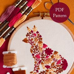 the embroidery pattern is being worked on with scissors and thread, along with other sewing supplies