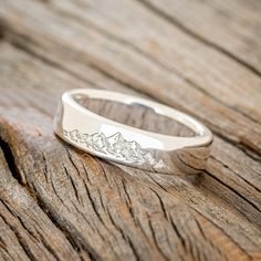 a silver ring sitting on top of a wooden table