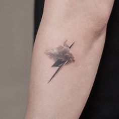 a black and white photo of a lightning tattoo on the left upper half of the arm