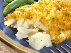 a blue plate topped with mashed potatoes and green beans