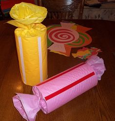 two wrapped gifts sitting on top of a wooden table