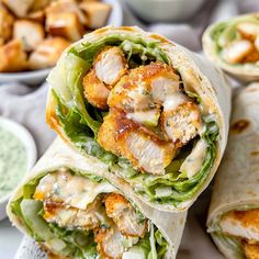 chicken wrap with lettuce and sauce on the side, ready to be eaten