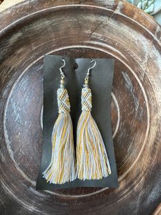 "BEADED TASSEL DROP EARRINGS ** IN STOCK & READY TO SHIP** These hand-assembled earrings are quite the beauty! They each feature beaded detailing with a multi-color tassel. We personally source and hand-pick our products directly from the craftspeople and families of Bali and other Indonesian Islands to ensure that you receive authentic and high-quality pieces. Our products are made traditionally by the locals of Indonesia using their craftmanship skills passed down for generations. Our miss Traditional Beaded Tassel Earrings, Traditional Adjustable Beaded Tassel Earrings, Adjustable Handwoven Dangle Tassel Earrings, Adjustable Beaded Earrings With Tassels As Gift, Adjustable Beaded Tassel Earrings As Gift, Yellow Tassel Earrings For Festival, Adjustable Yellow Bohemian Tassel Earrings, Yellow Bohemian Adjustable Tassel Earrings, Bohemian Yellow Adjustable Tassel Earrings