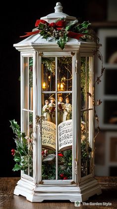 a lighted lantern with christmas decorations on it