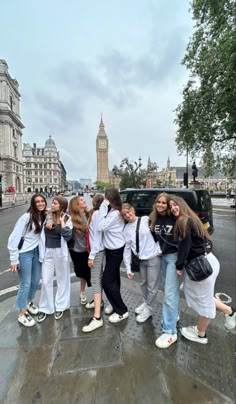 a group of young women standing on the side of a road