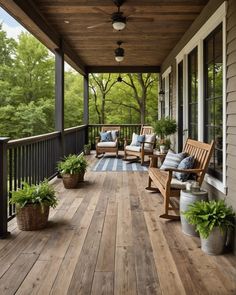 a wooden porch with chairs and plants on it