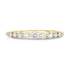 a yellow gold ring with three diamonds on the side and four smaller stones in the middle