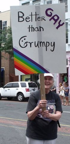 a woman holding a sign that says better than grumpy